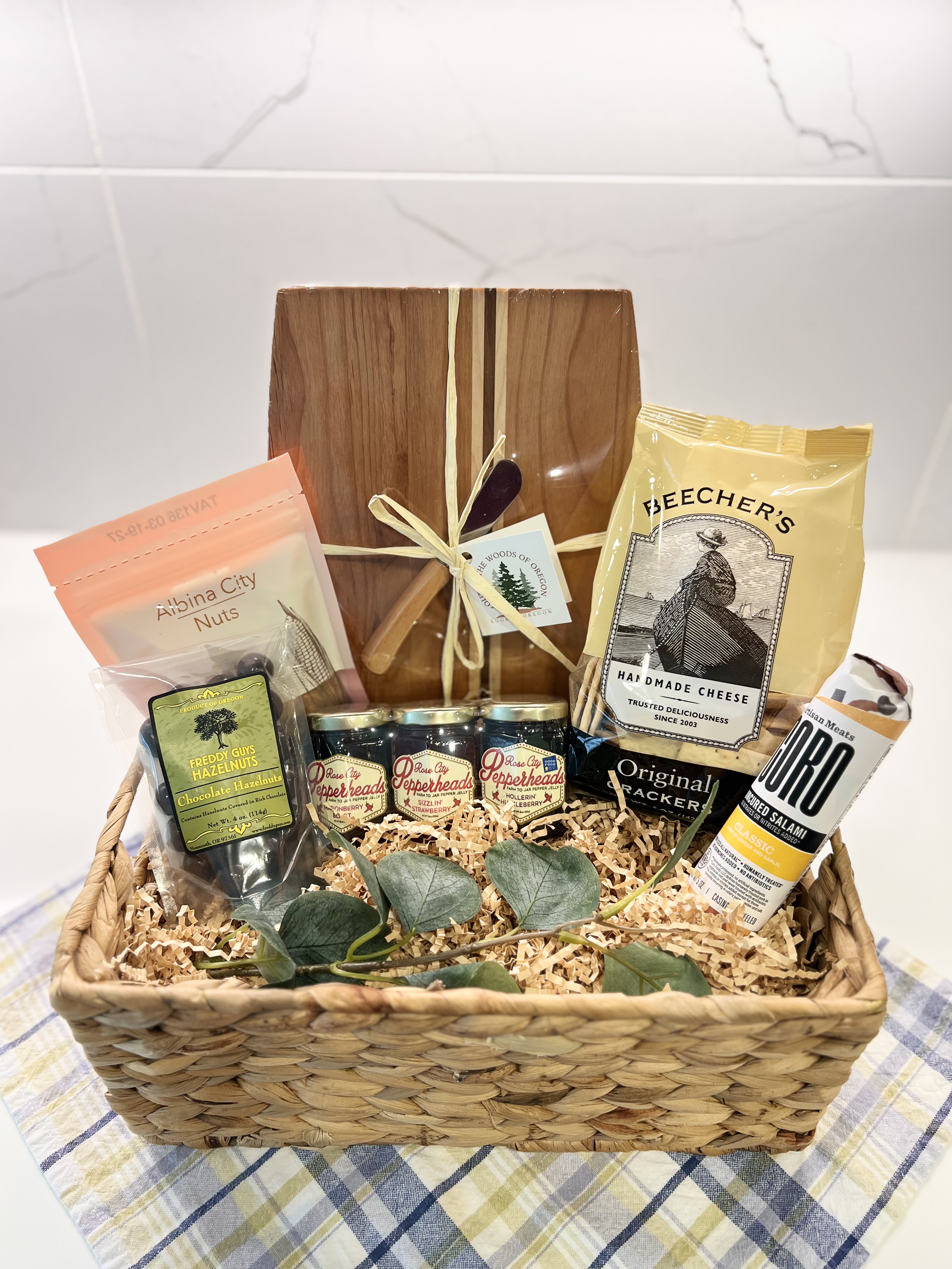 Charcuterie gift basket with board, salami, and crackers