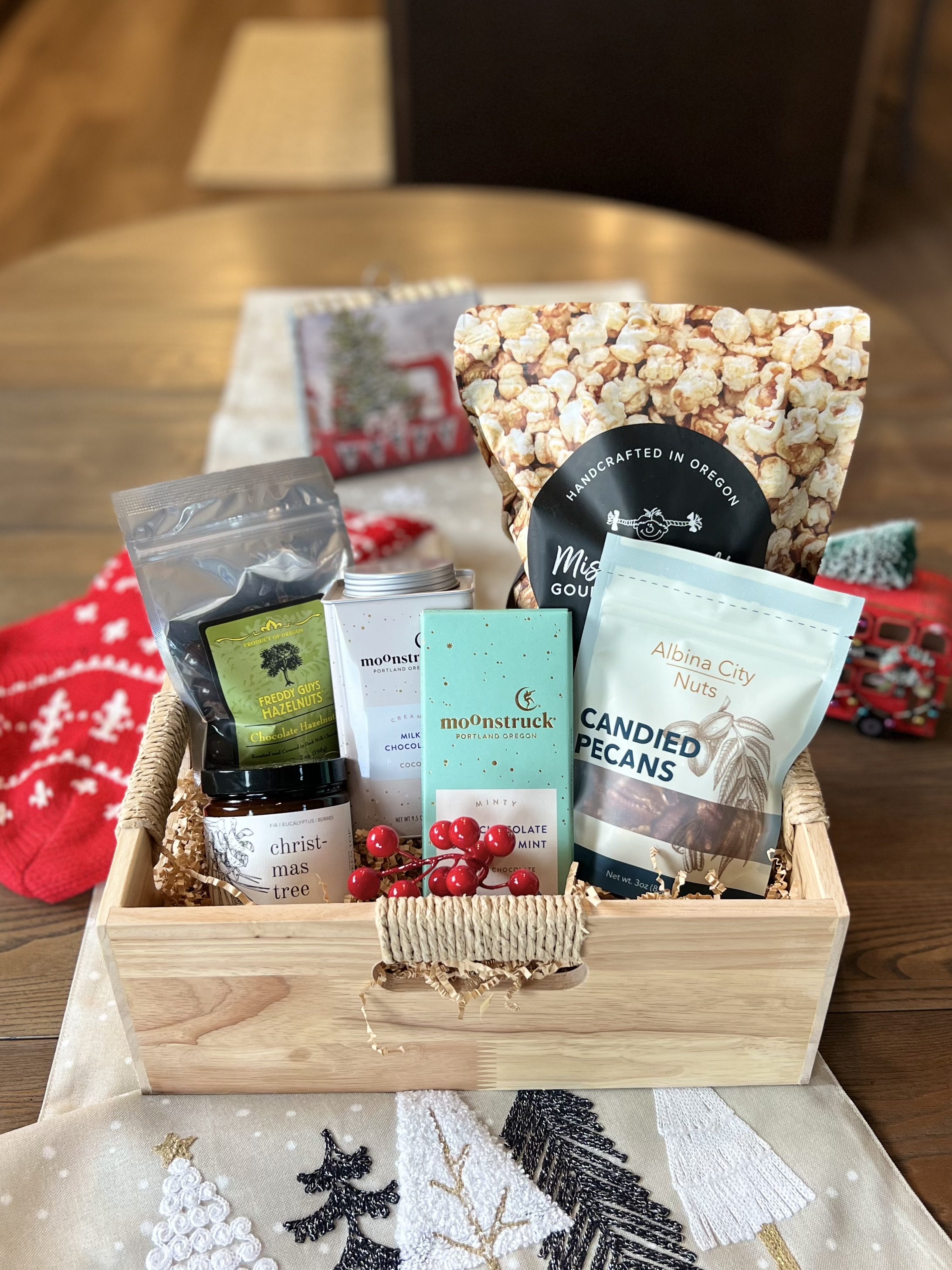 Holiday gift basket with cocoa, popcorn, and a Christmas candle